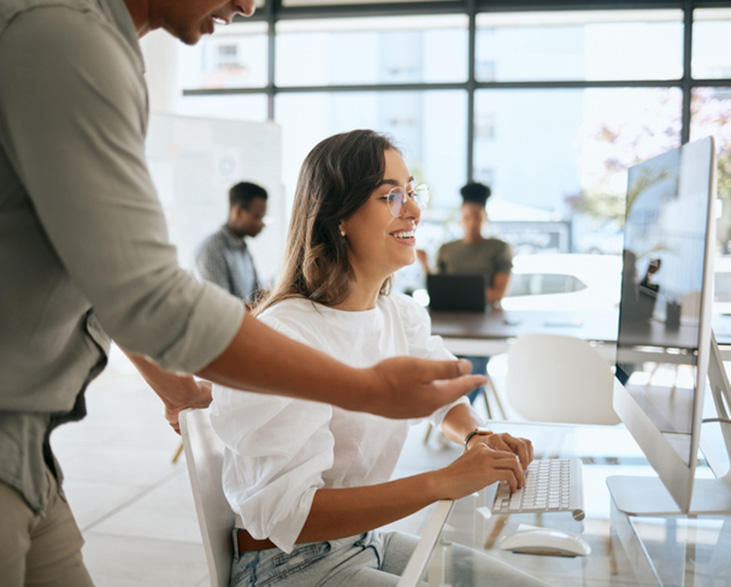 two people working on website design on computer